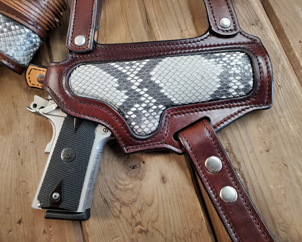 A handgun inside a leather holster 