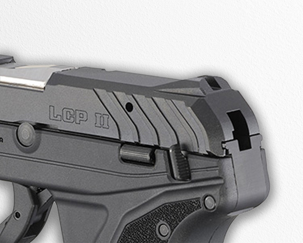 A detailed close-up of the Ruger LCP II handgun, showing the rear slide serrations, external safety features, and part of the frame.