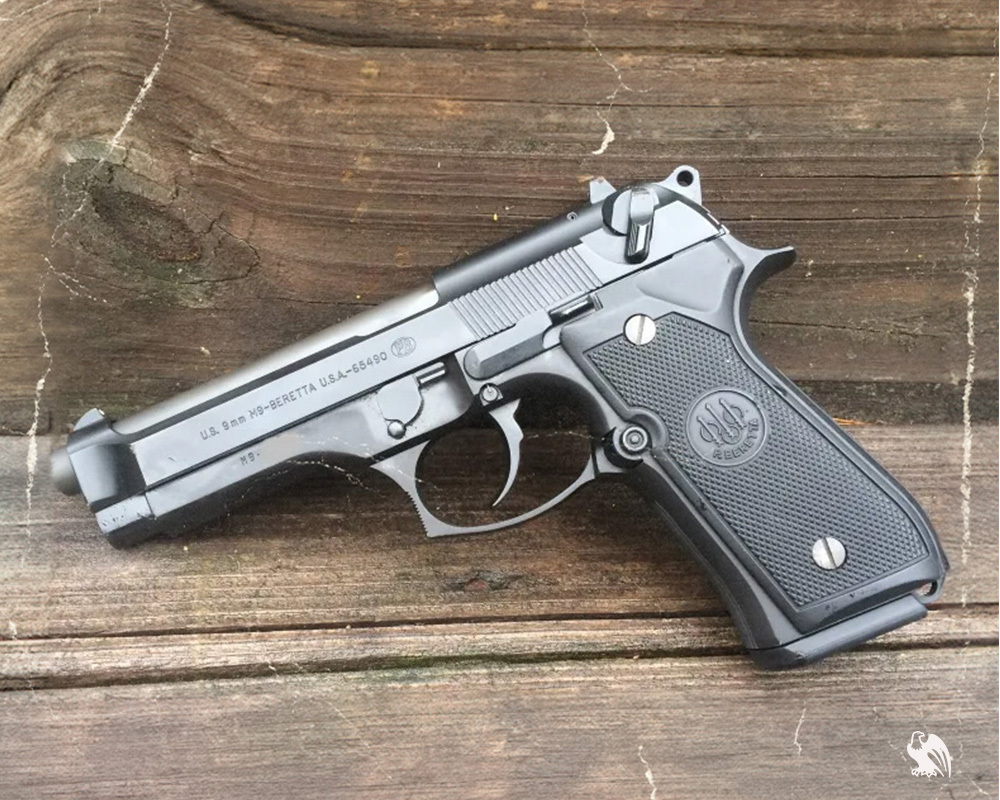 Beretta M9 Handgun played on a wood surface.
