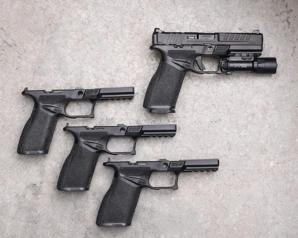 One handgun including a light and 3 gun frames with no light, no trigger and the slide. 