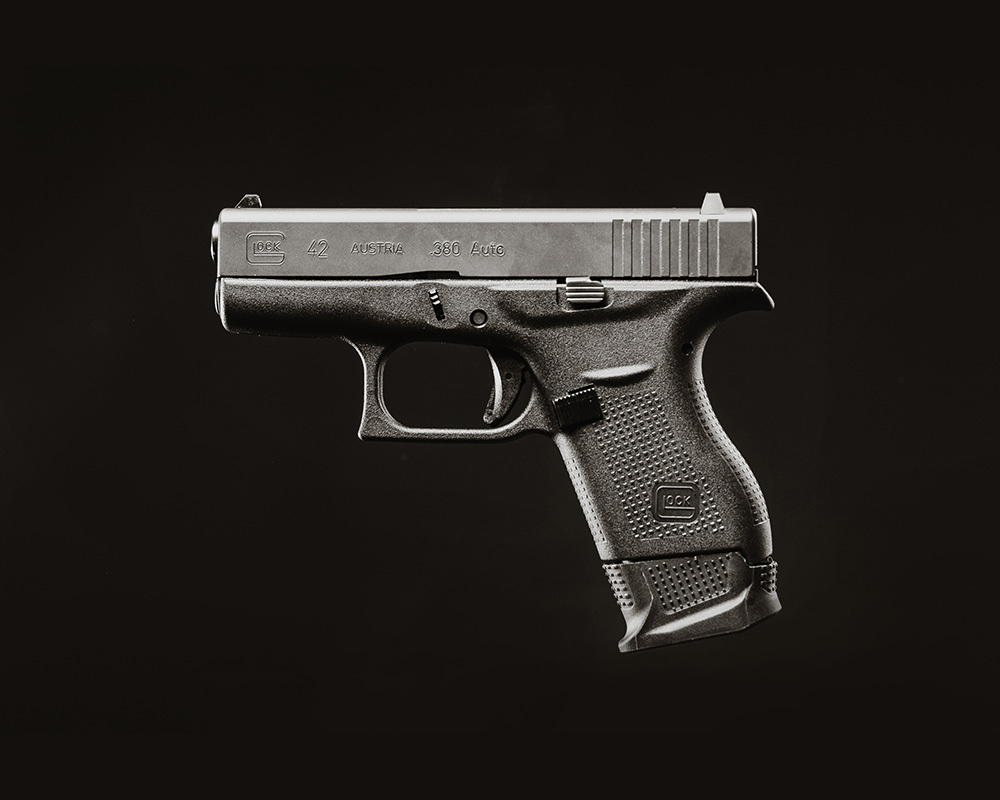 Glock 42 displayed on its side with a black background.