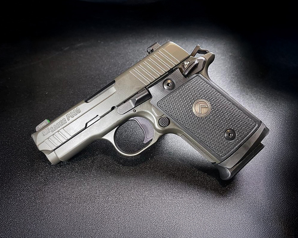 Sig Sauer P938 Sitting on a black table, ideal for concealed carry and everyday self-defense.