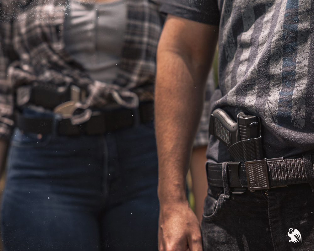 A man and woman carrying a Ruger LCP on their concealed Vedder Holsters