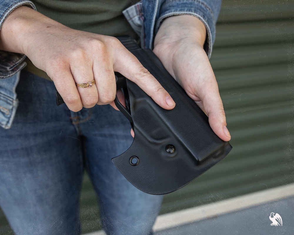 Woman holding a Pocket Locker Holster from Vedder Holsters. 