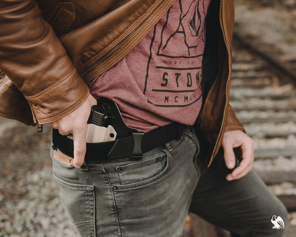 Man ready to release their handgun out of a IWB Kydex Holster from Vedder Holsters