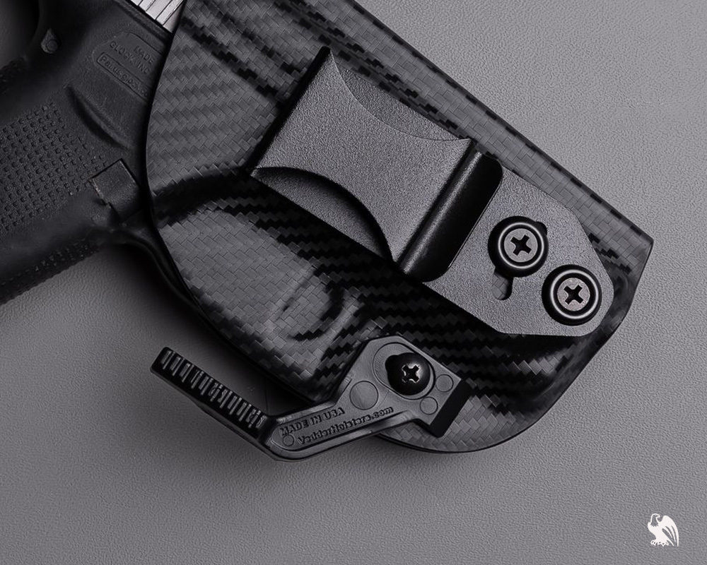 A close up of a Vedder Holsters Lighttuck with a claw attached. 