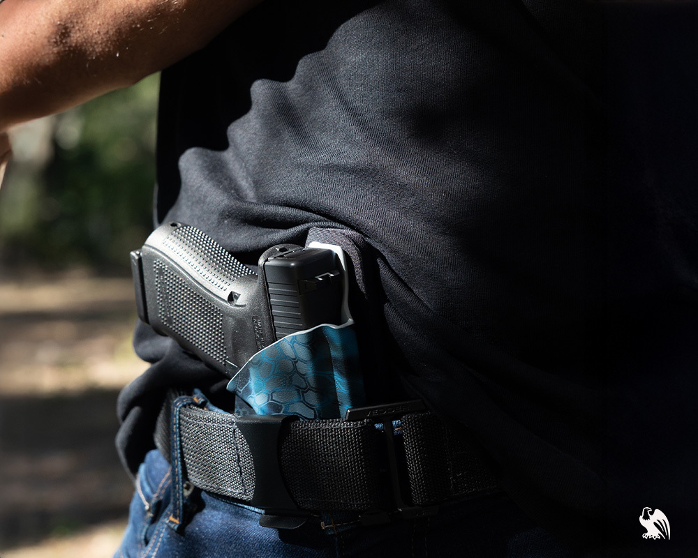 Man carrying a Vedder Holster to conceal his Beretta M9 handgun.