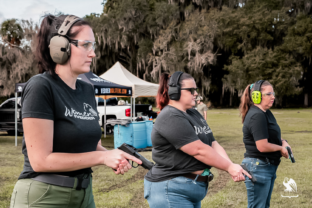 Women at the shooting range ready to take a shot at the target - Find your community