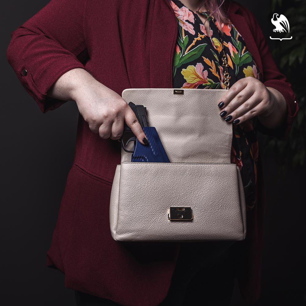 Accessibility - Woman drawing holstered handgun from her purse. Pocket Holster from Vedder Holsters