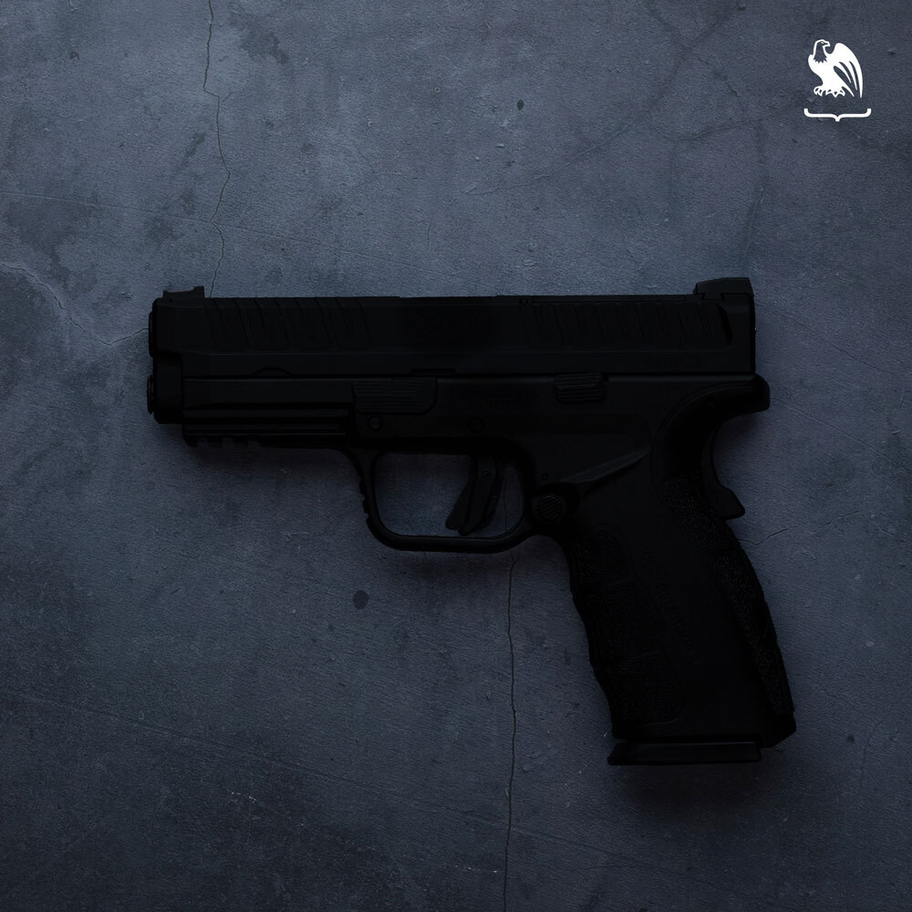 Black handgun representing a ghost gun displayed on a dark textured surface for firearm safety and concealed carry reference.