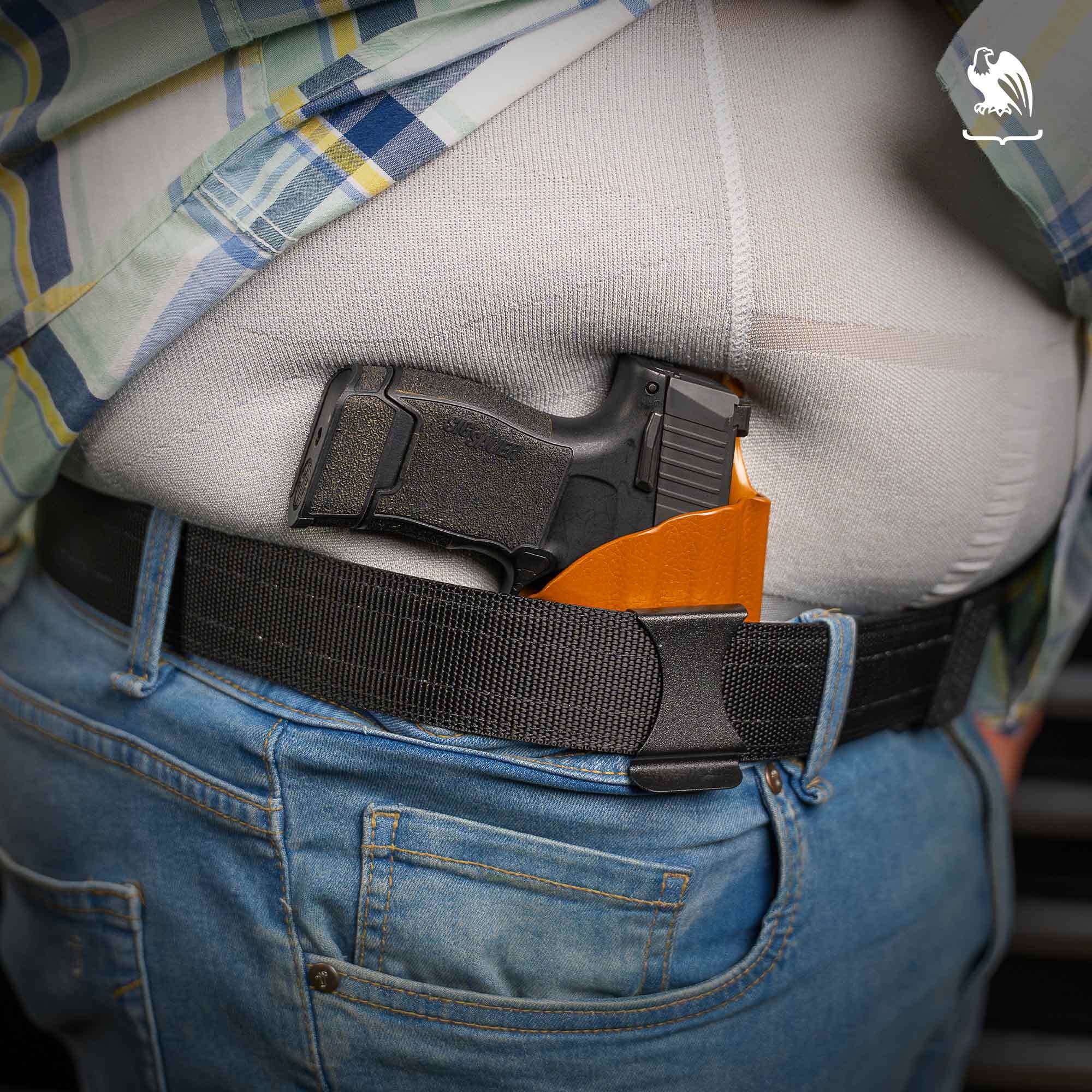 Best Carry Position for Big Guys A heavyset man carries a pistol in a brown Vedder Holsters LightTuck in the 2 o'clock position.