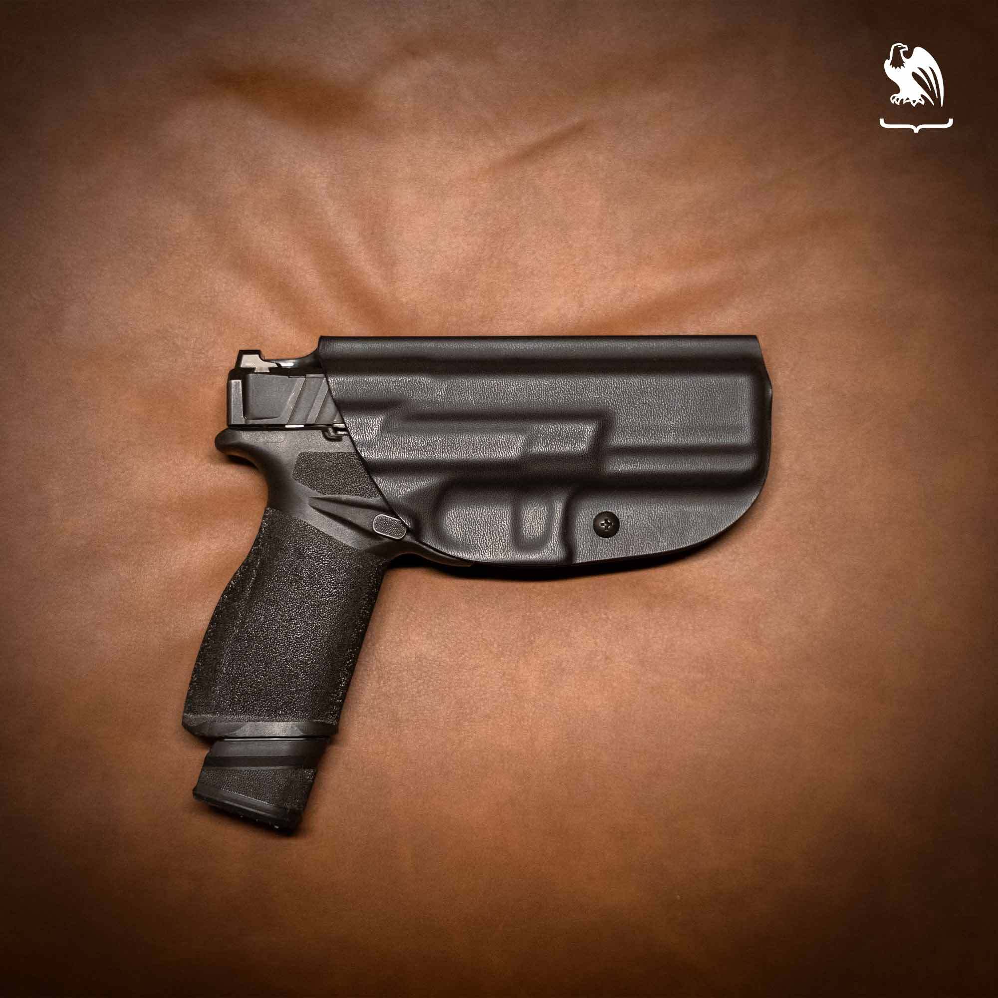 A Springfield Armory Echelon in a black Vedder Holsters ProDraw holster on a brown background
