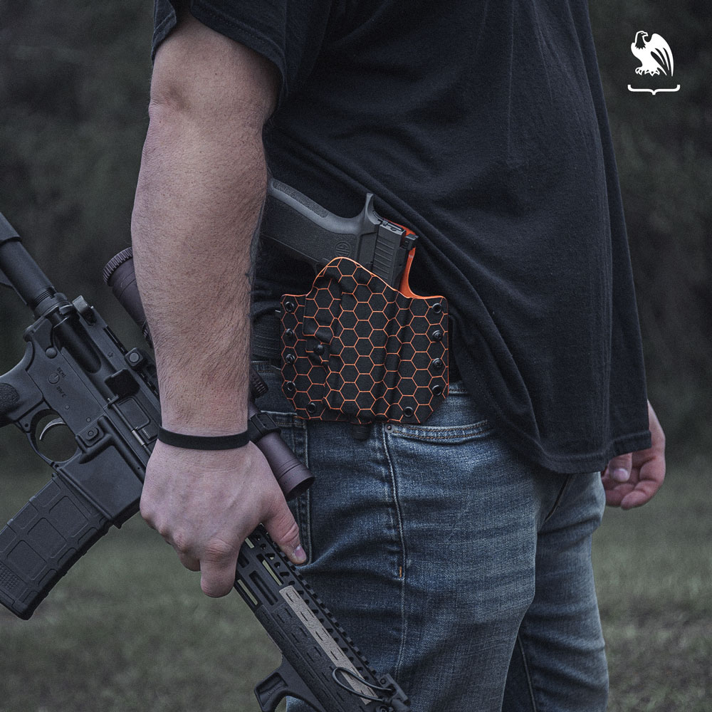 Vedder Holster Stock Photography - Carrying OWB and holding a Rifle