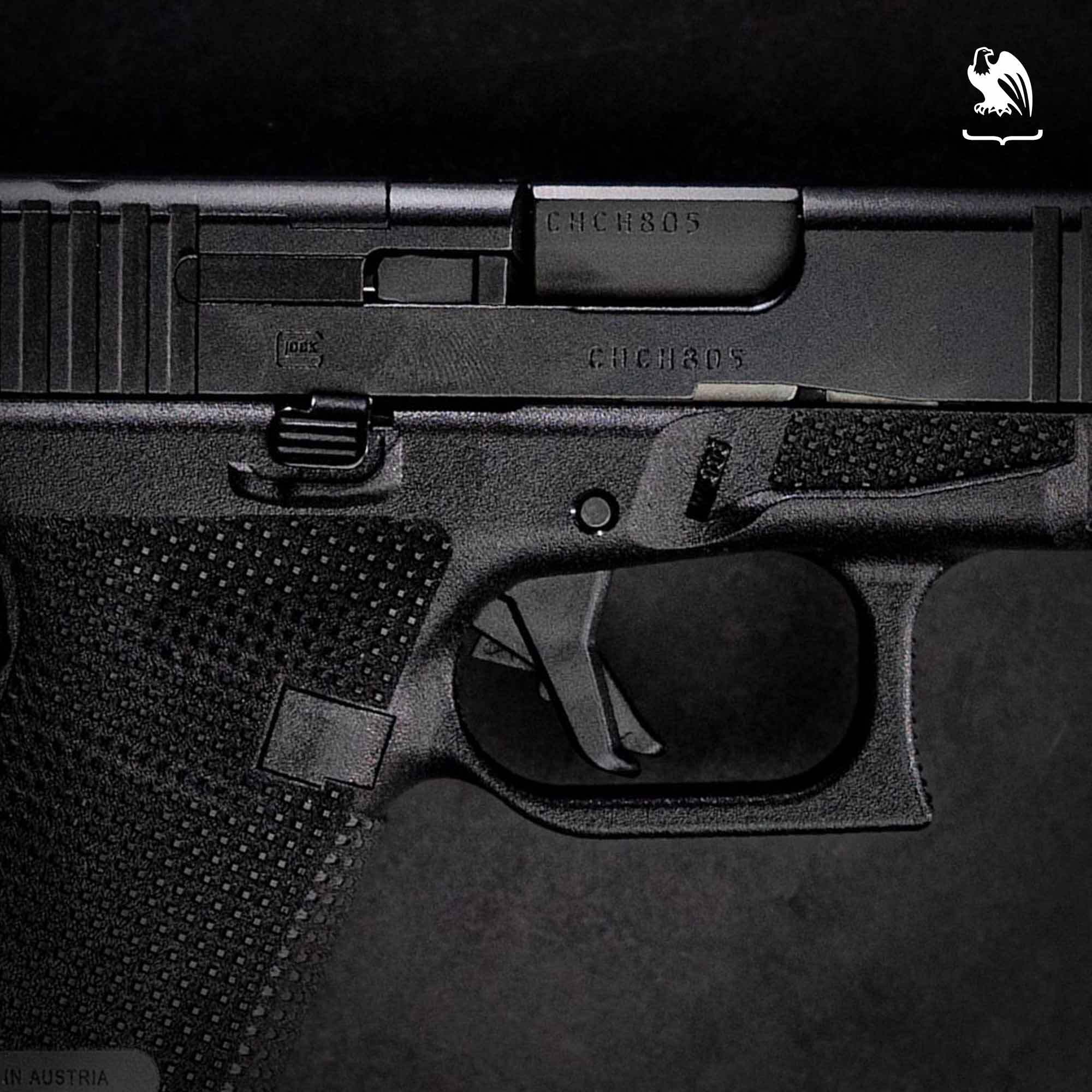 A close-up of a Glock 19 pistol's controls