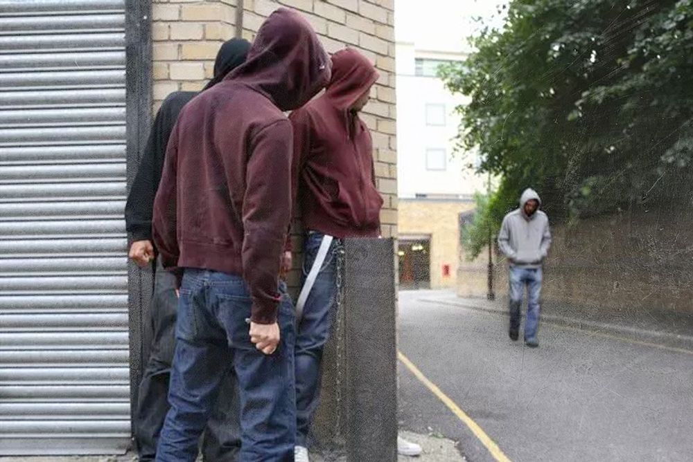 3 men with bad intention suspicious looking  at a walking pedestrian