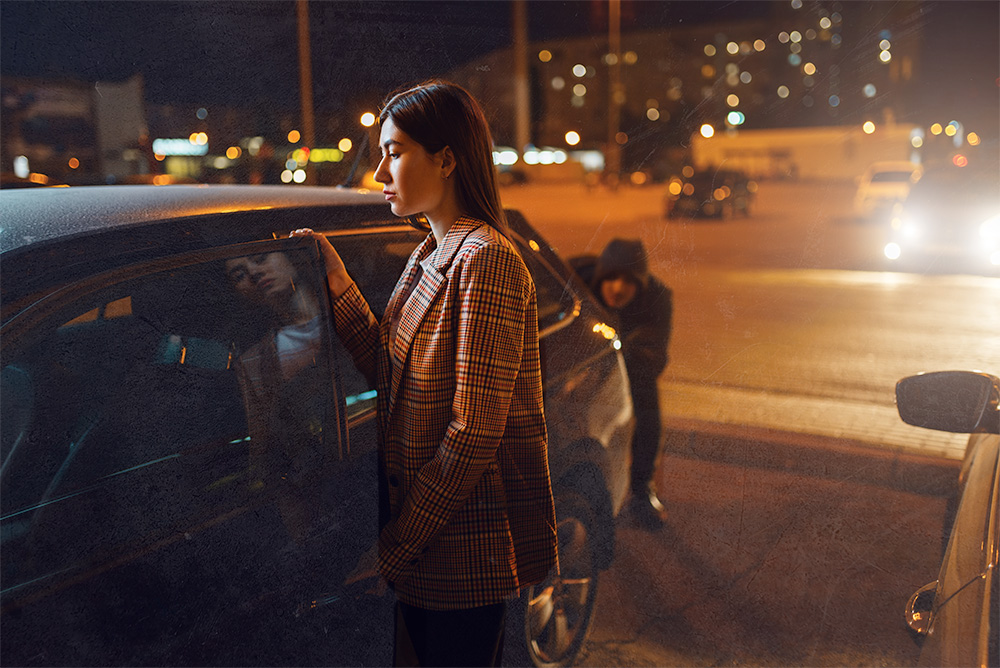 Suspicious Man lucking from behind a car while woman is entering the vehicle