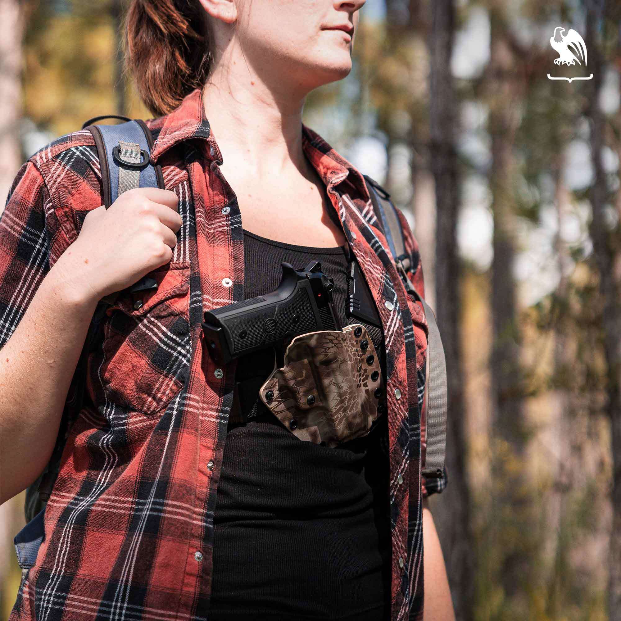 Woman outdoors carrying a Evertrek Chest Holster with her handgun keeping herself safe at all times.