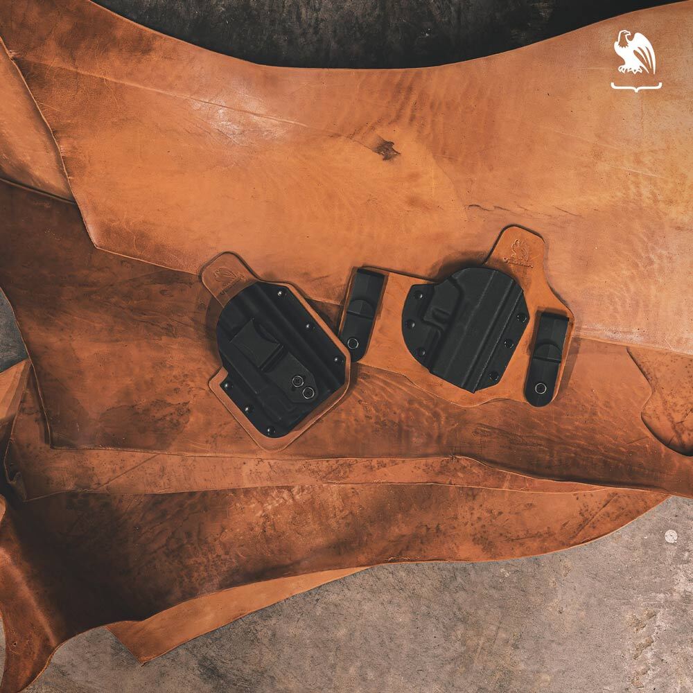 Vedder Holsters hybrid leather and Kydex holsters displayed on a rugged Horween leather hide, showcasing premium craftsmanship and durable concealed carry design.