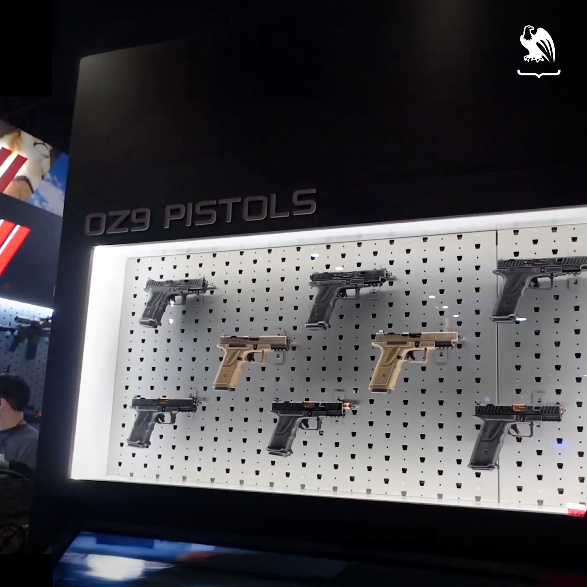 OZ9 Pistols display featuring multiple semi-automatic handguns mounted on a wall exhibit at the SHOT Show 2026 firearms trade show.