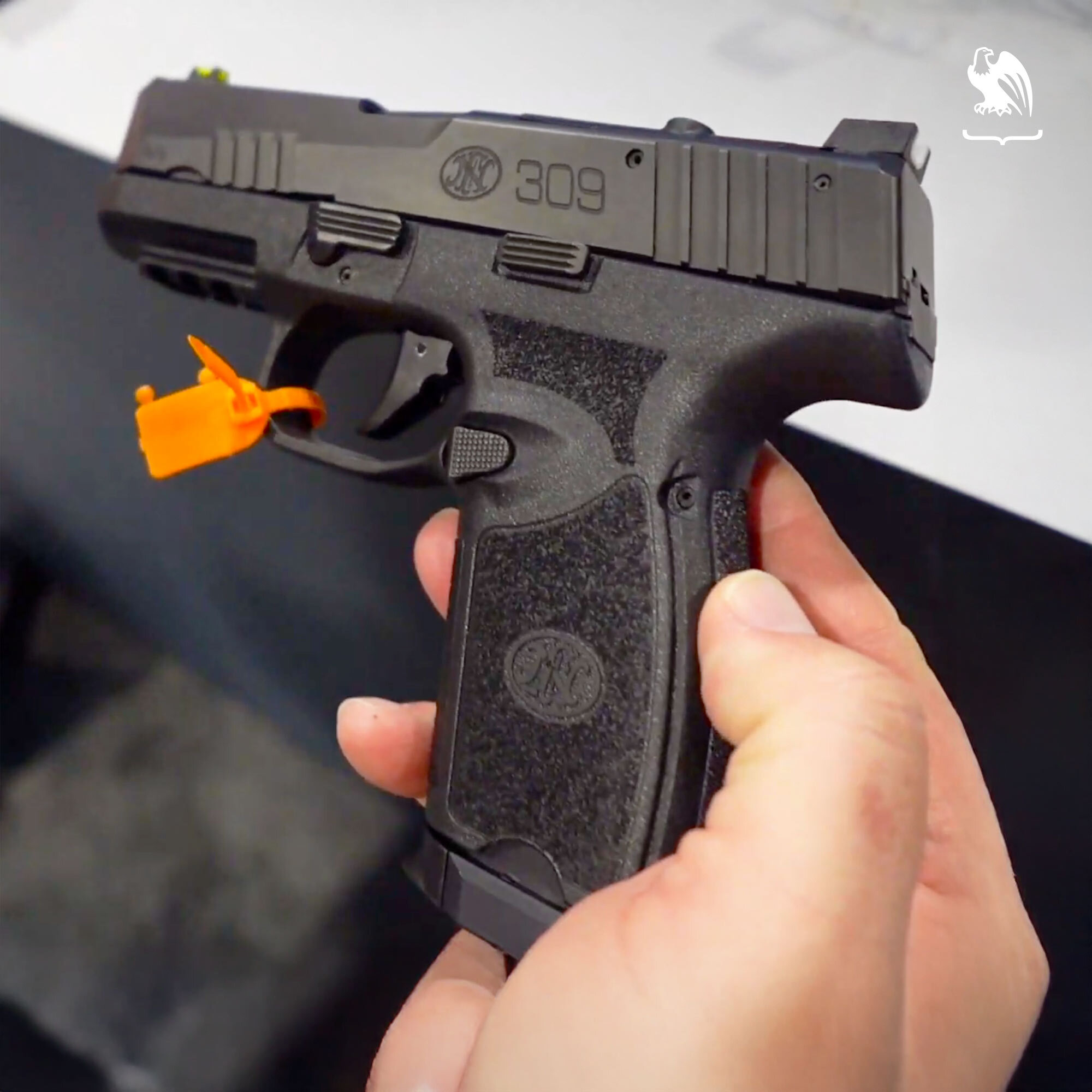 FN 309 MRD compact 9mm pistol in black, featuring an internal hammer design, optics-ready slide, and textured grip.