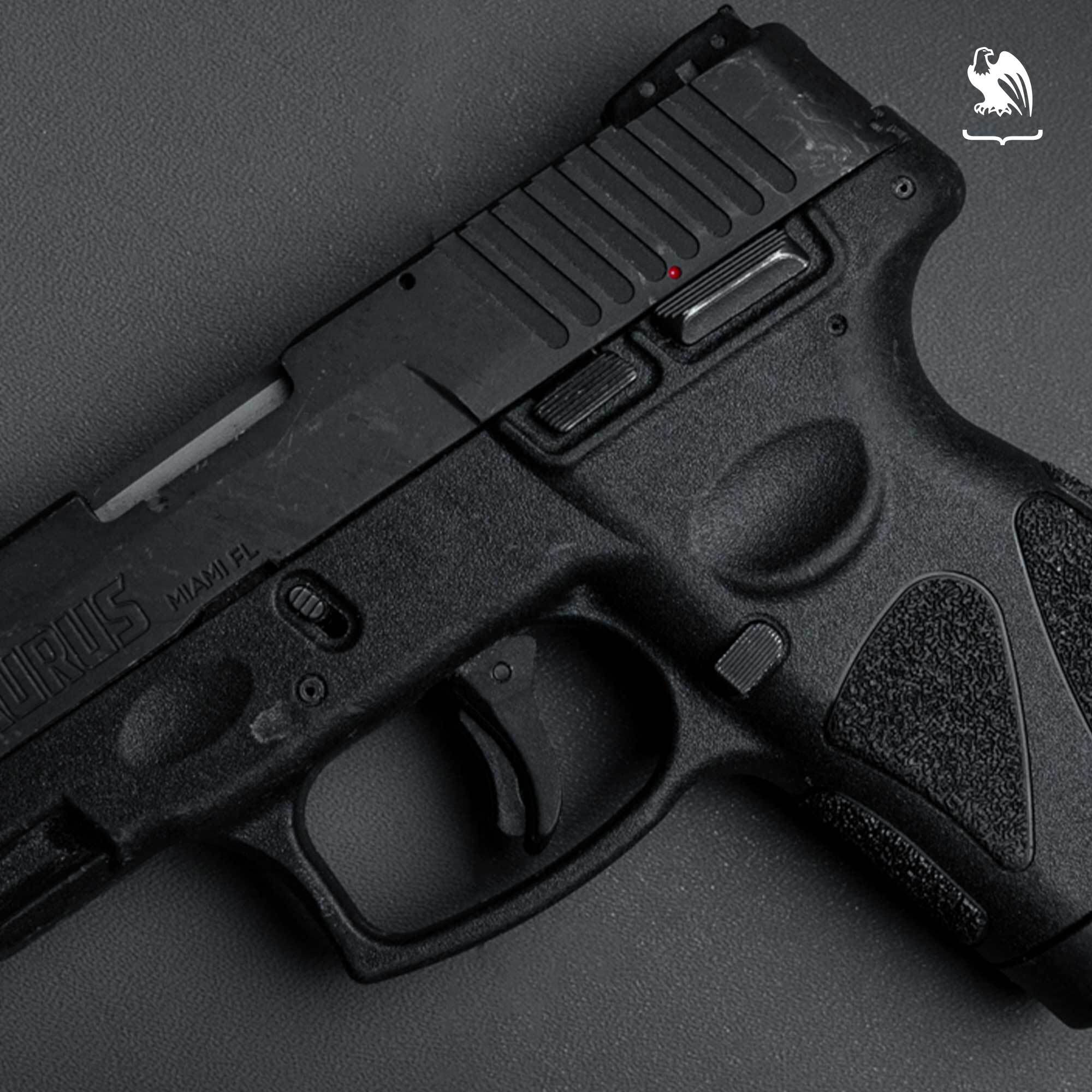 Close-up of the Taurus G2C controls, including the manual safety, slide lock, and trigger guard.