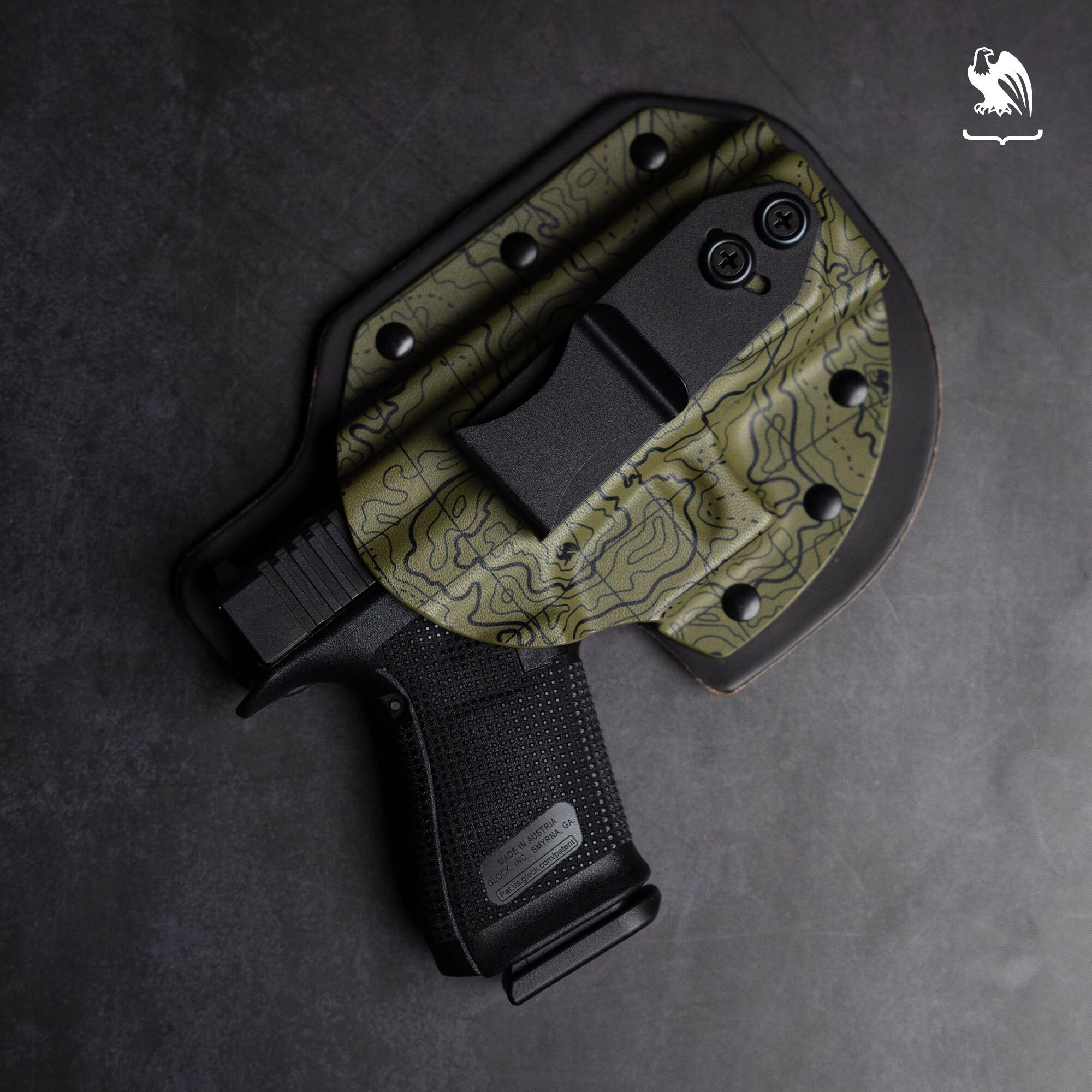 Vedder Holsters hybrid IWB holster in OD Green Topographic Kydex with black leather backing and a Glock pistol.