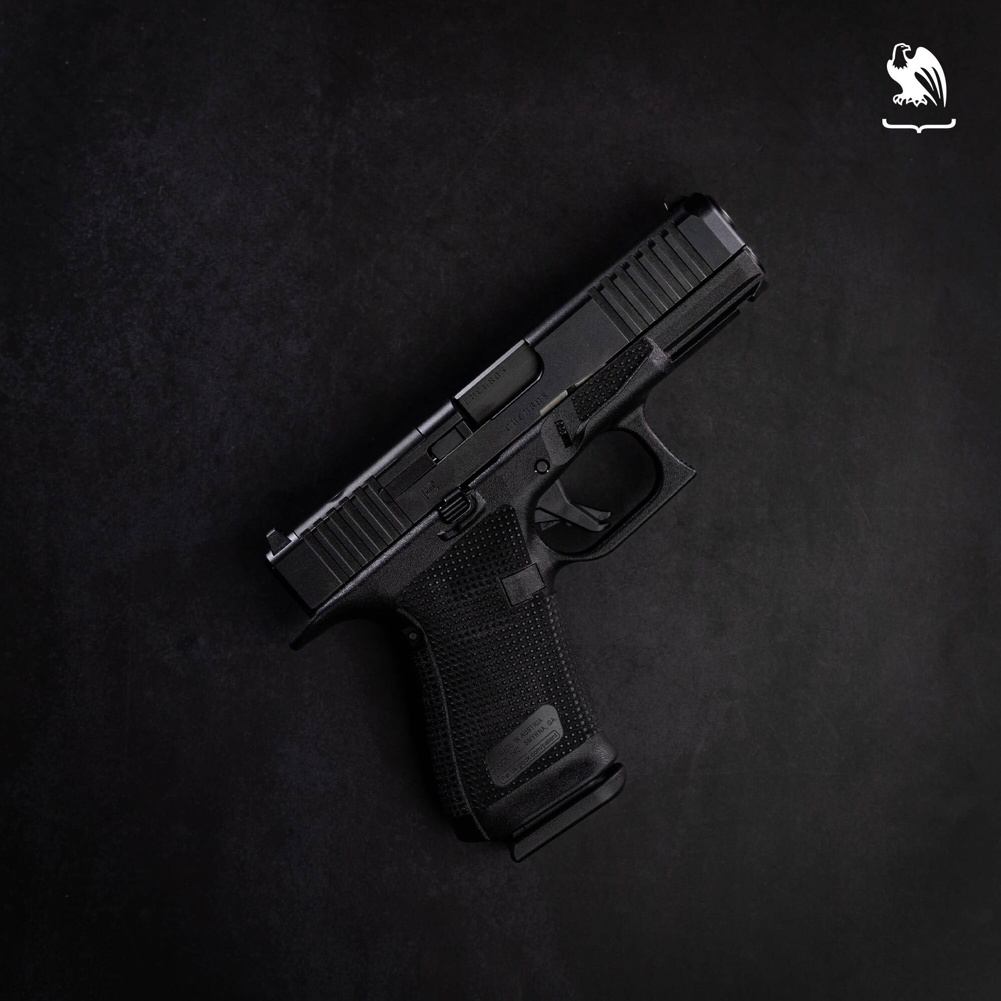 A Glock 19 pistol on a black background