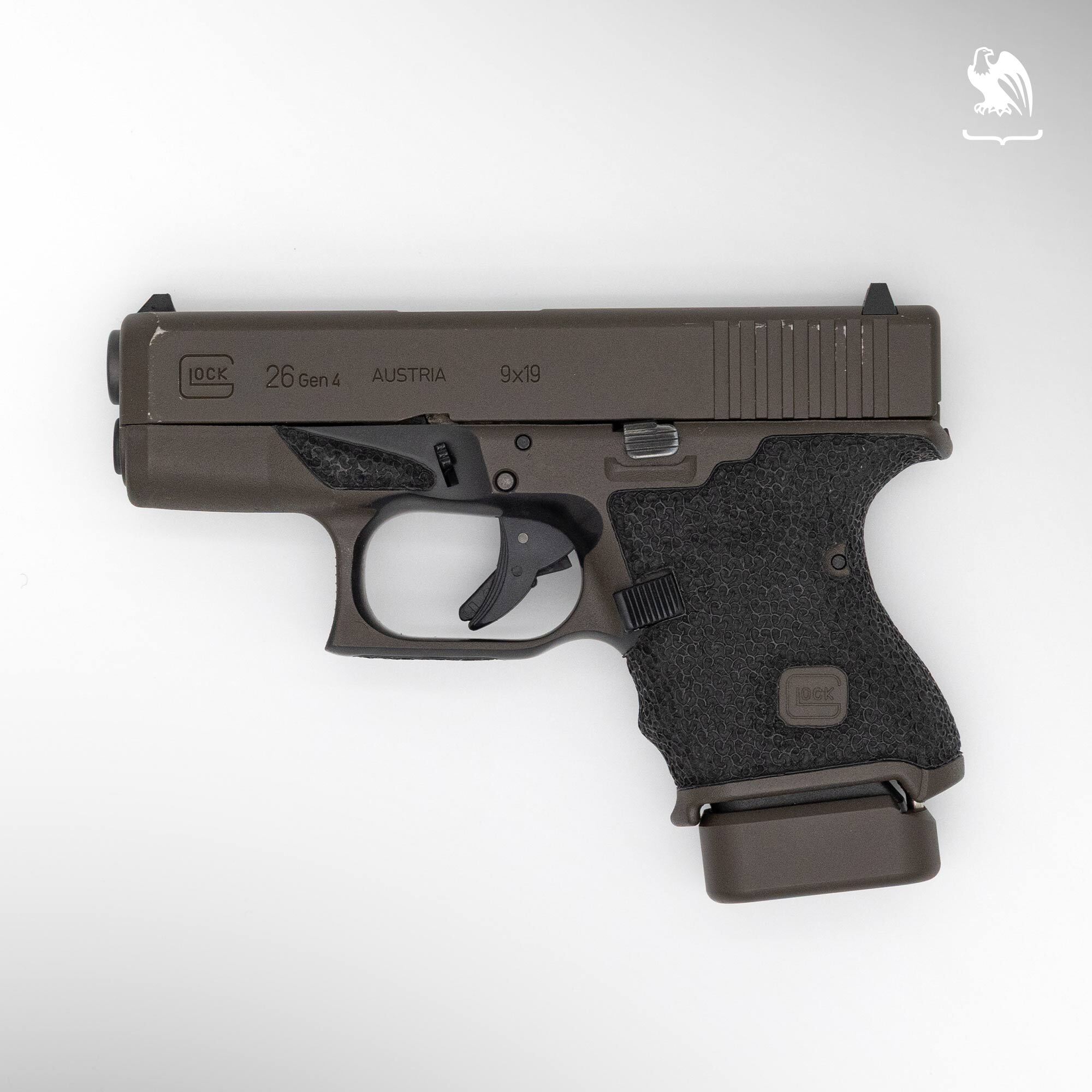 Glock 26 Gen 4 subcompact 9mm pistol in FDE finish with textured grip and extended magazine base plate, side profile view