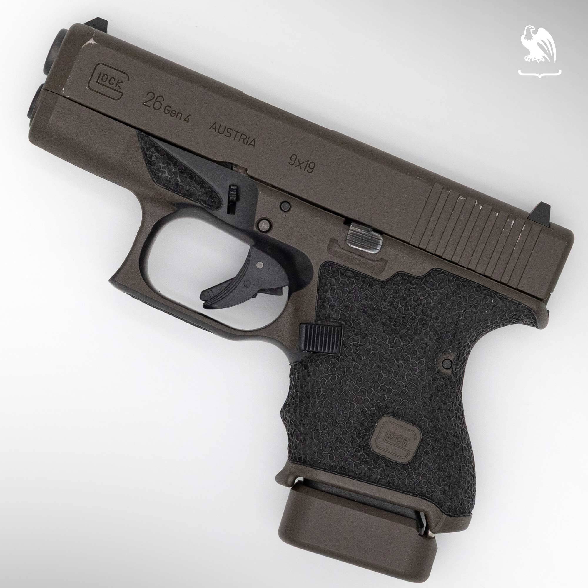 Glock 26 Gen 4 subcompact 9mm pistol in FDE finish showing Safe Action trigger system and stippled grip, angled top view
