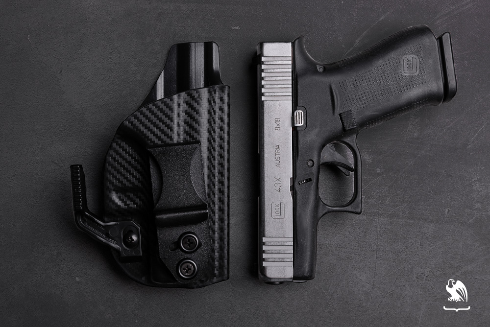 Top angle photography of a Glock 43X and a Vedder Holster Lighttuck IWB Holster