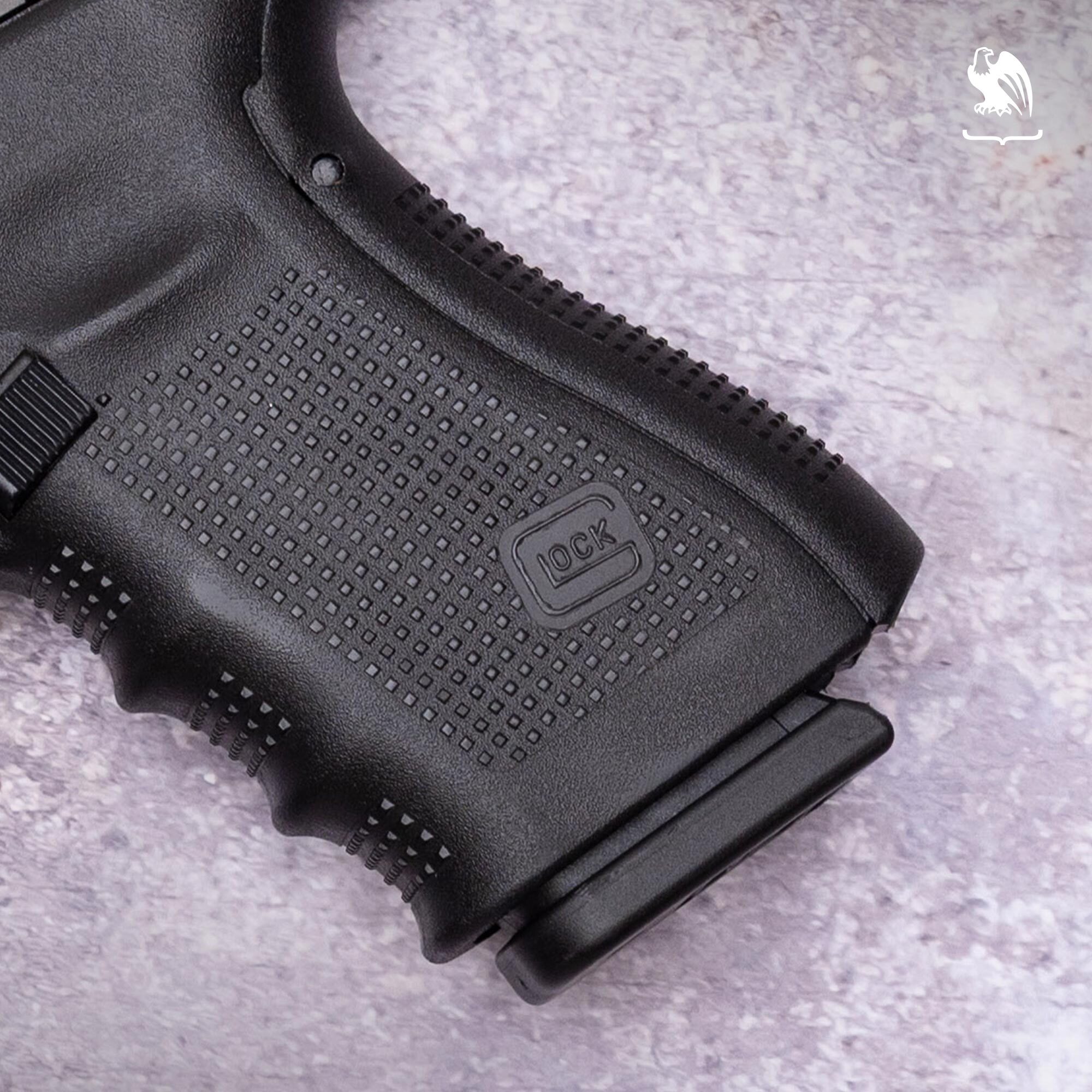 Glock semi-automatic pistol grip and magazine well detail with embossed logo.