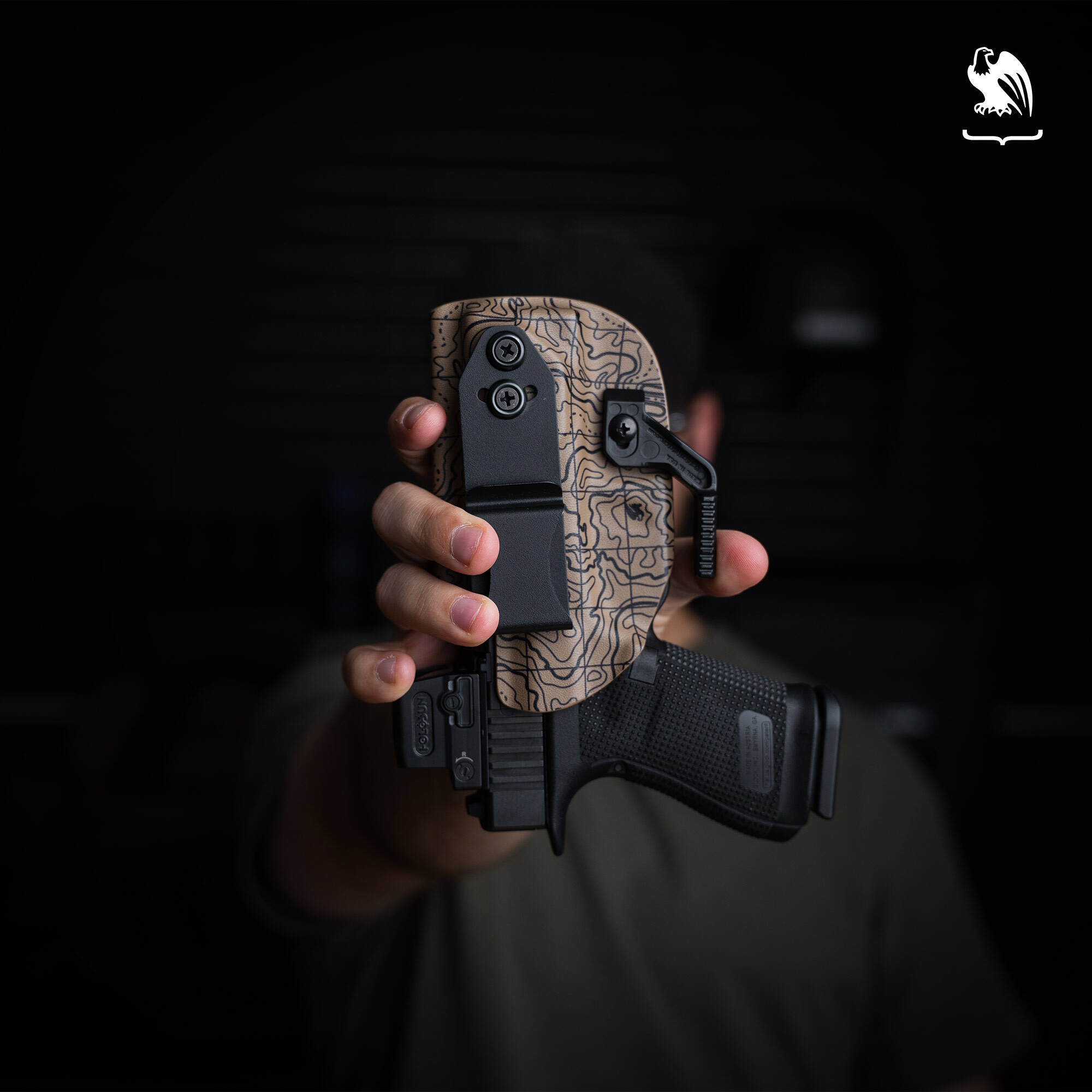 Upside Down Vedder LightTuck A man holds a pistol in a Vedder Holsters LightTuck upside down to test its retention