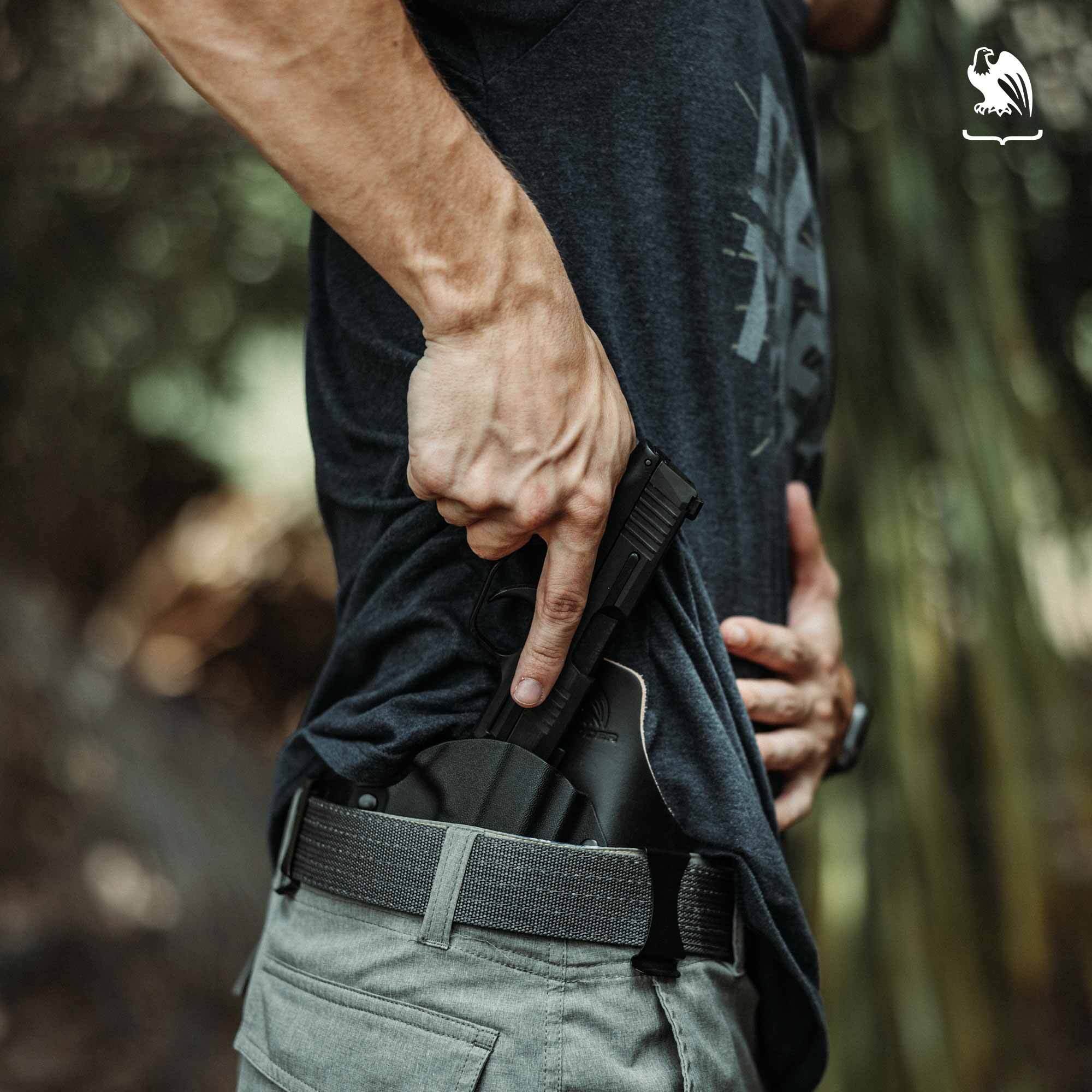 Man drawing a handgun from a Vedder Holsters Hybrid IWB Holster, designed for comfort, durability, and effective concealed carry.