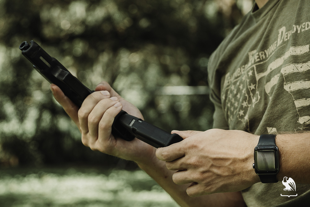 Man loading mag into handgun