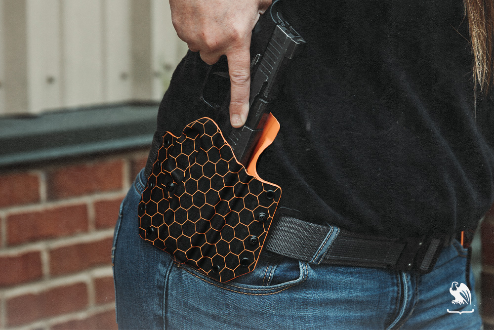 Female drawing her gun from a LightDraw OWB holster from Vedder Holsters