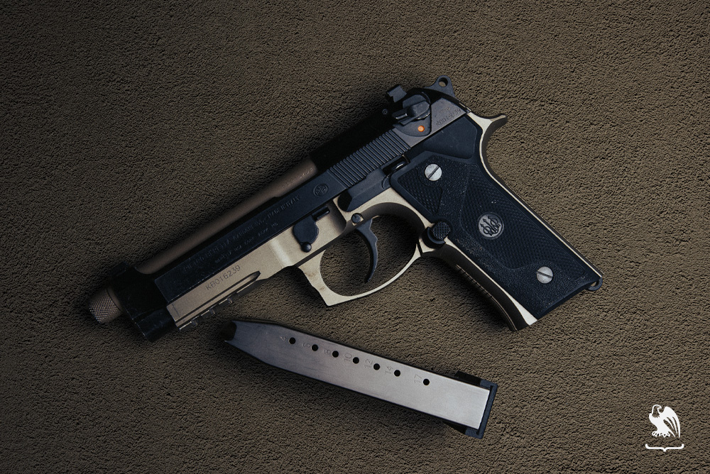 A Beretta M9A3 gun laying down along side its magazine - Size and Capacity