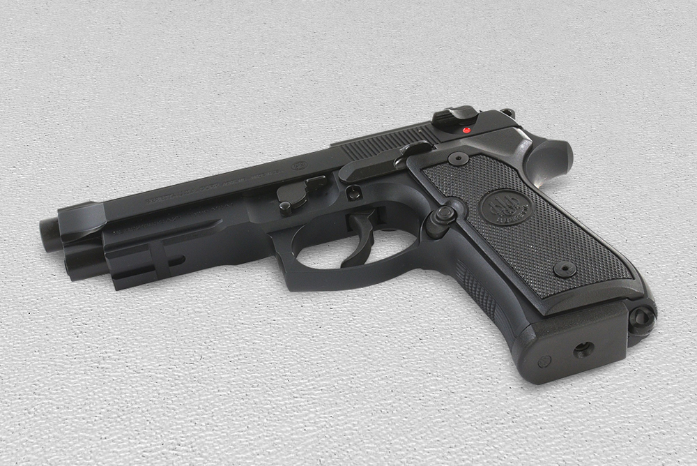 Close up imagery of the Beretta M9A1 gun laying on a flat surface