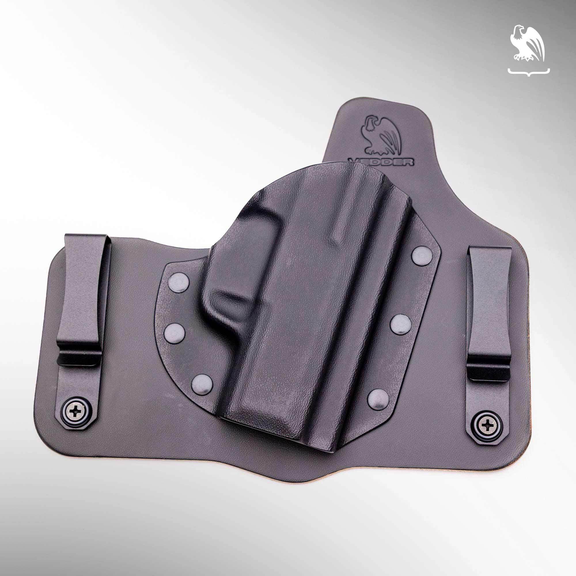 A Vedder Holsters ComfortTuck holster with a black cowhide leather backing