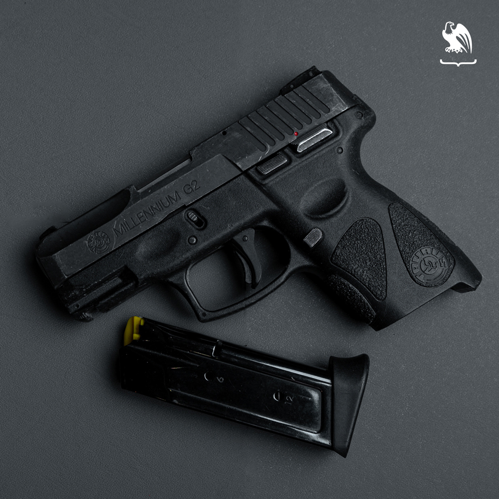 Taurus PT111 with its magazine laying down on a table