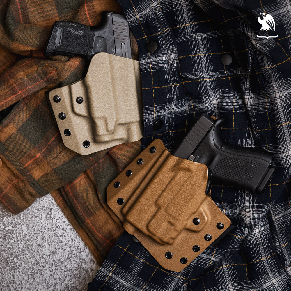 A Sig Sauer P320 and a Glock holstered each on a Lighttuck OWB Kydex Holster, layed on top of flannel shirts.