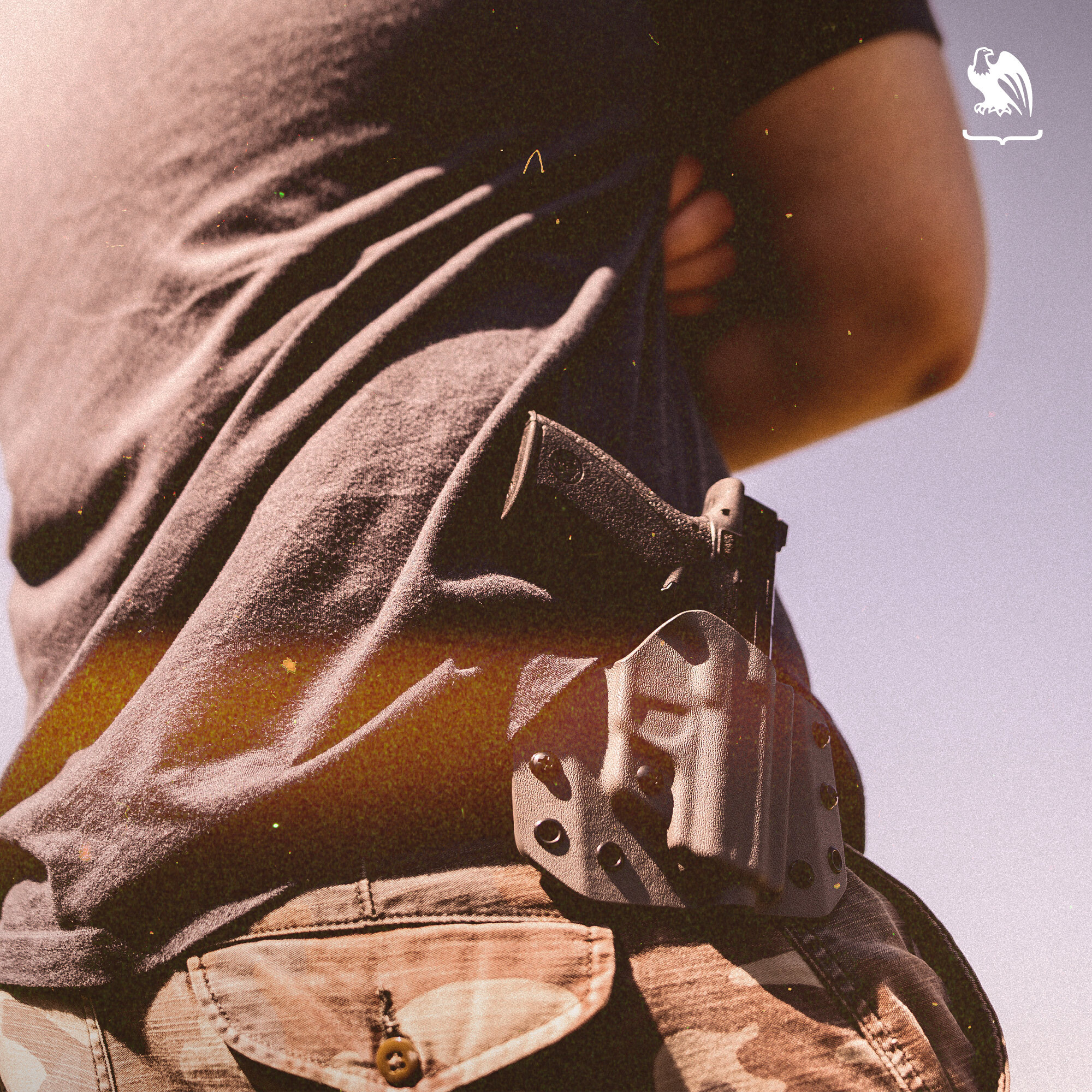 Backside picture of a man carrying a OWB holster from Vedder Holsters with his handgun. 