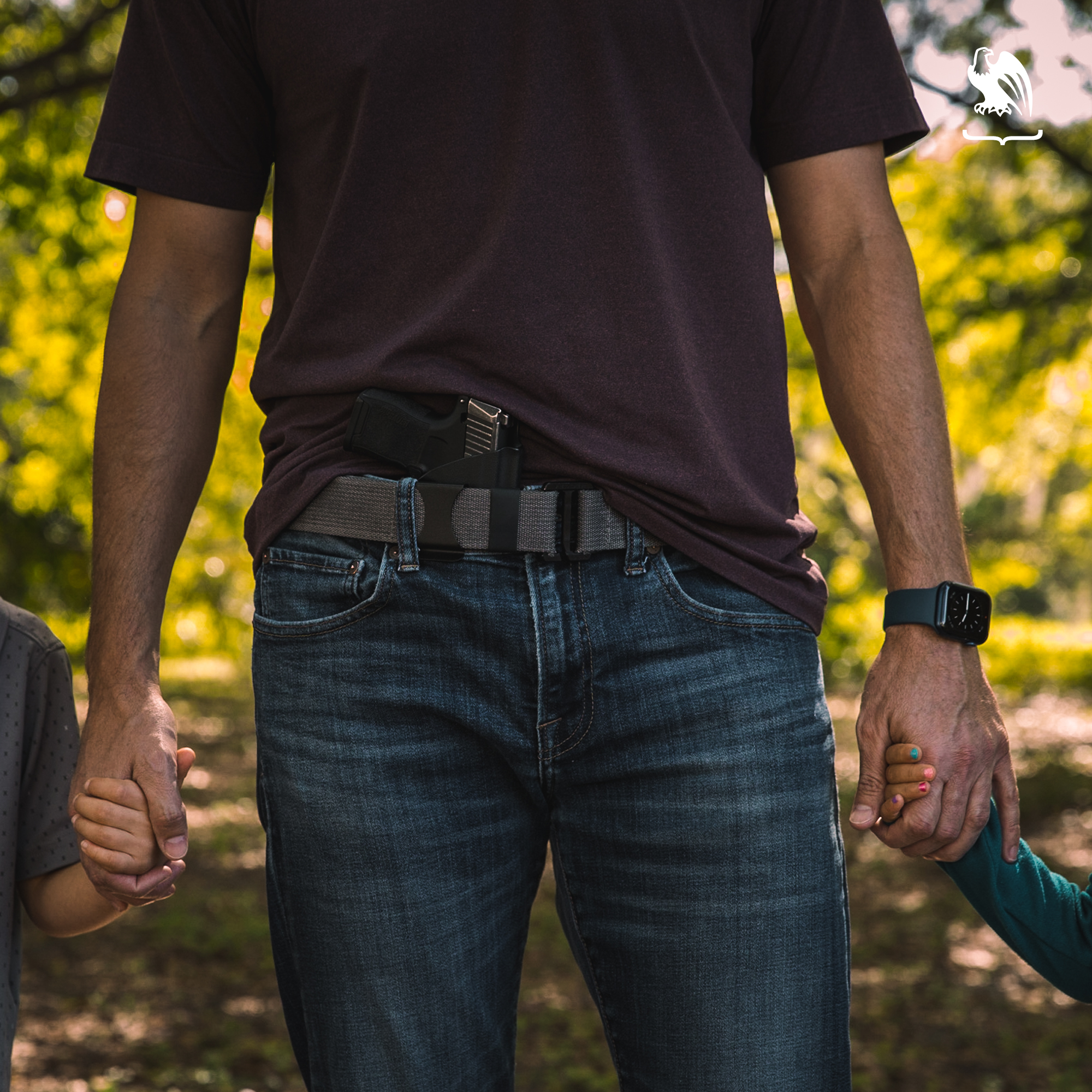 Generic Image of father holding kids hands while concealed carrying