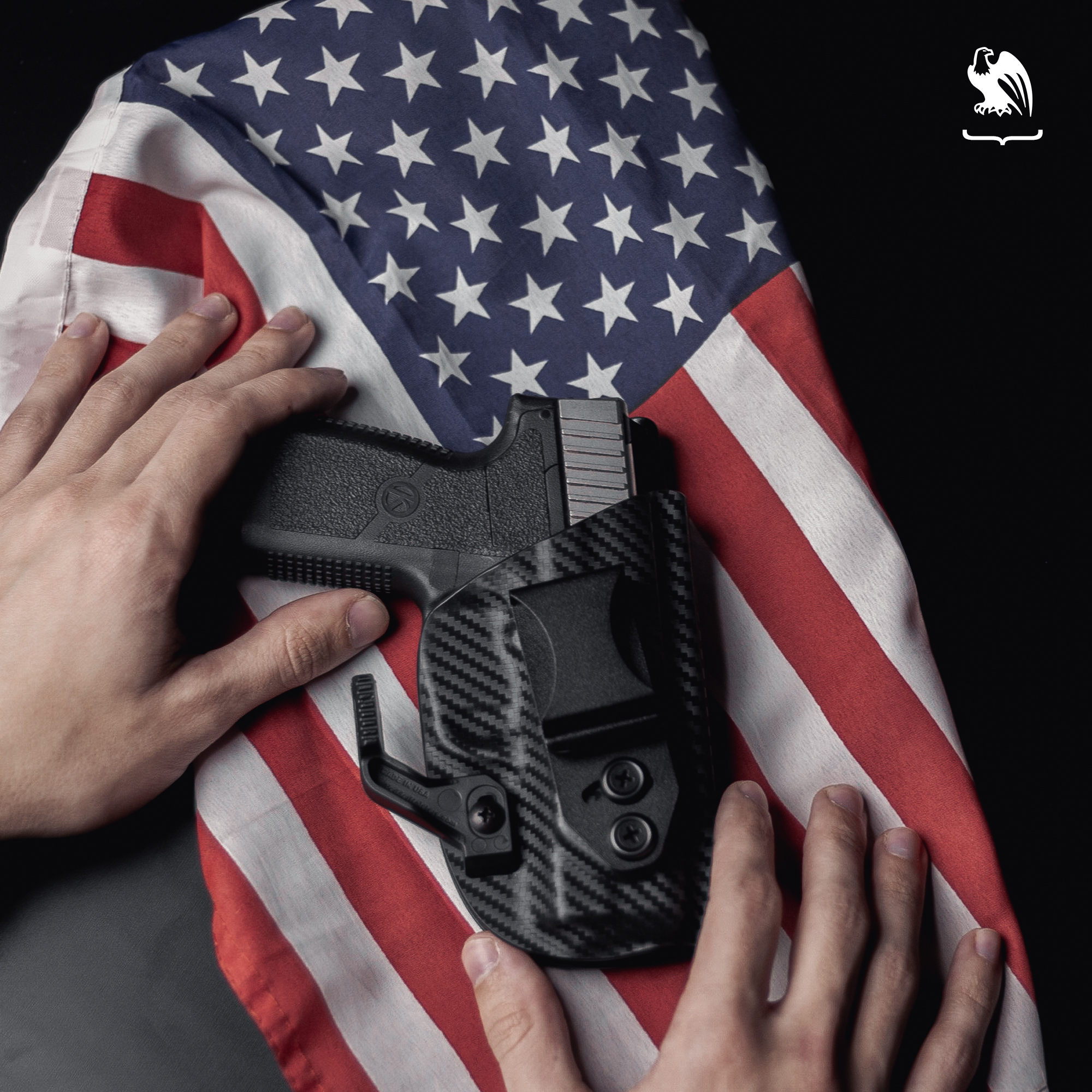 Handgun inside a Vedder Holster laying on top of the American Flag