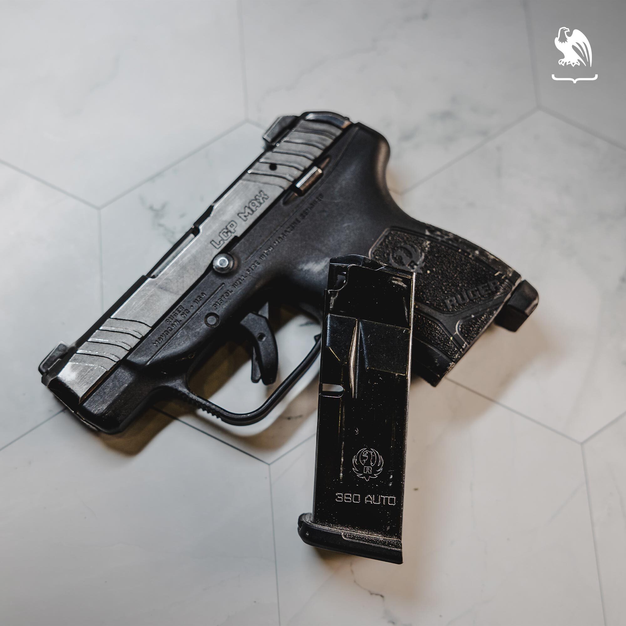 Angled top-down view of a compact semi-automatic handgun next to a magazine, emphasizing grip design, slide markings, and size factors relevant to personal self-defense and everyday carry.