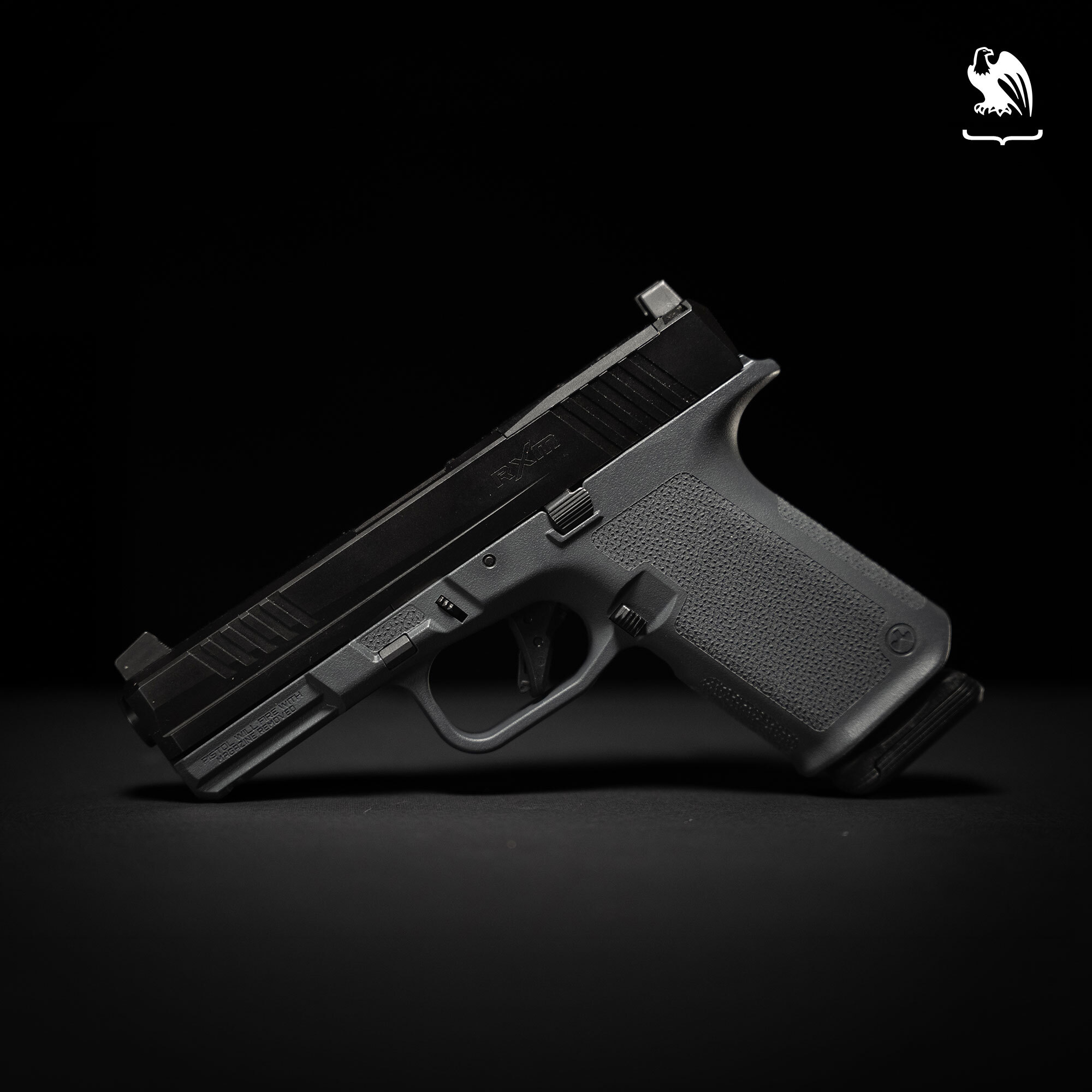 A Ruger RXM pistol against a black backdrop