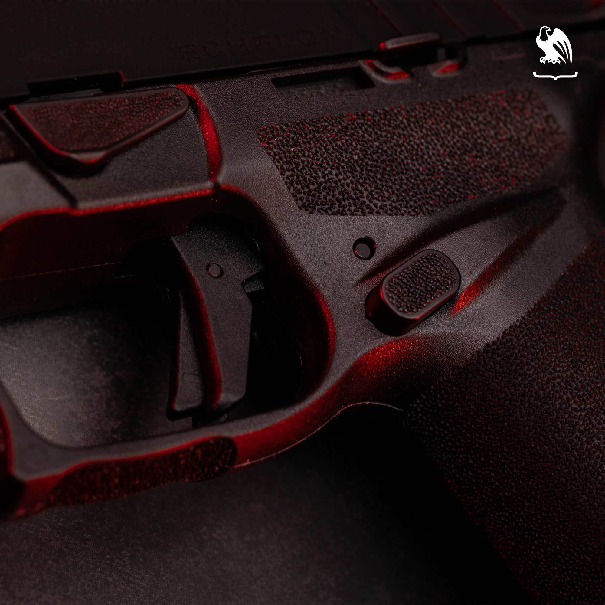 Close-up of a handgun trigger and textured grip frame highlighting the trigger safety and ergonomic design.