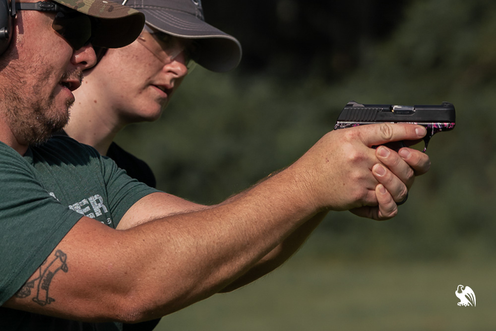 A man pulling out handgun with red dot sight from a Vedder Holsters Pocket Locker Holster.