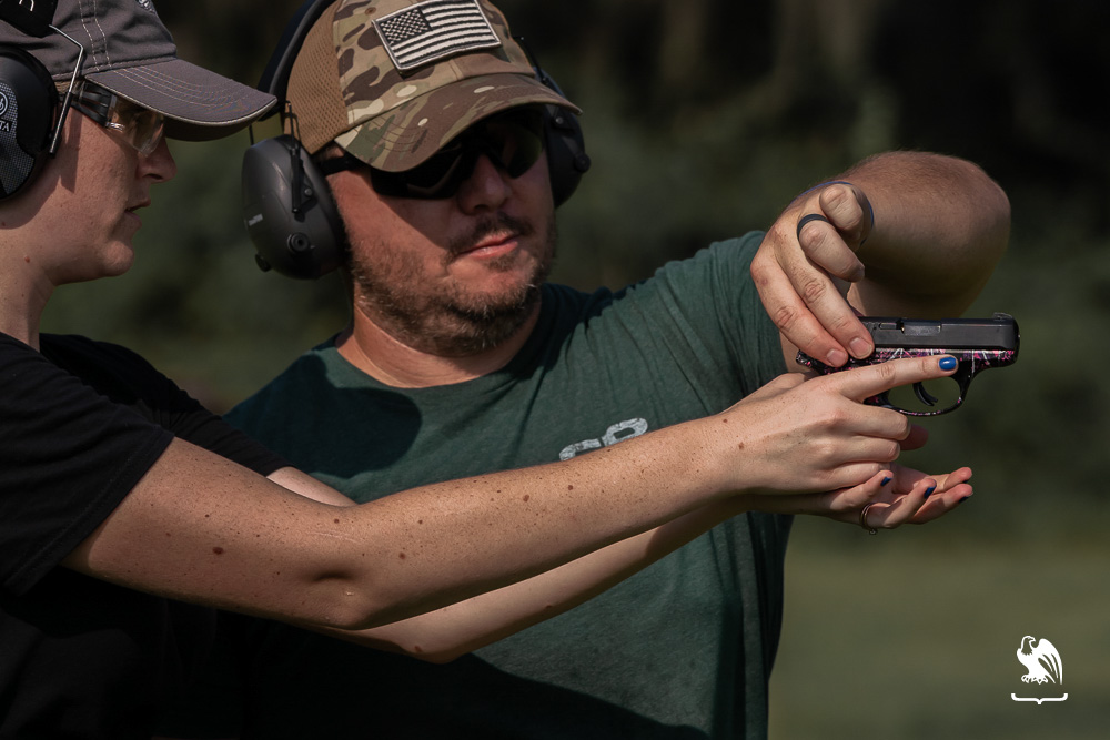 Instructor teaching lady about gun unintentional discharge