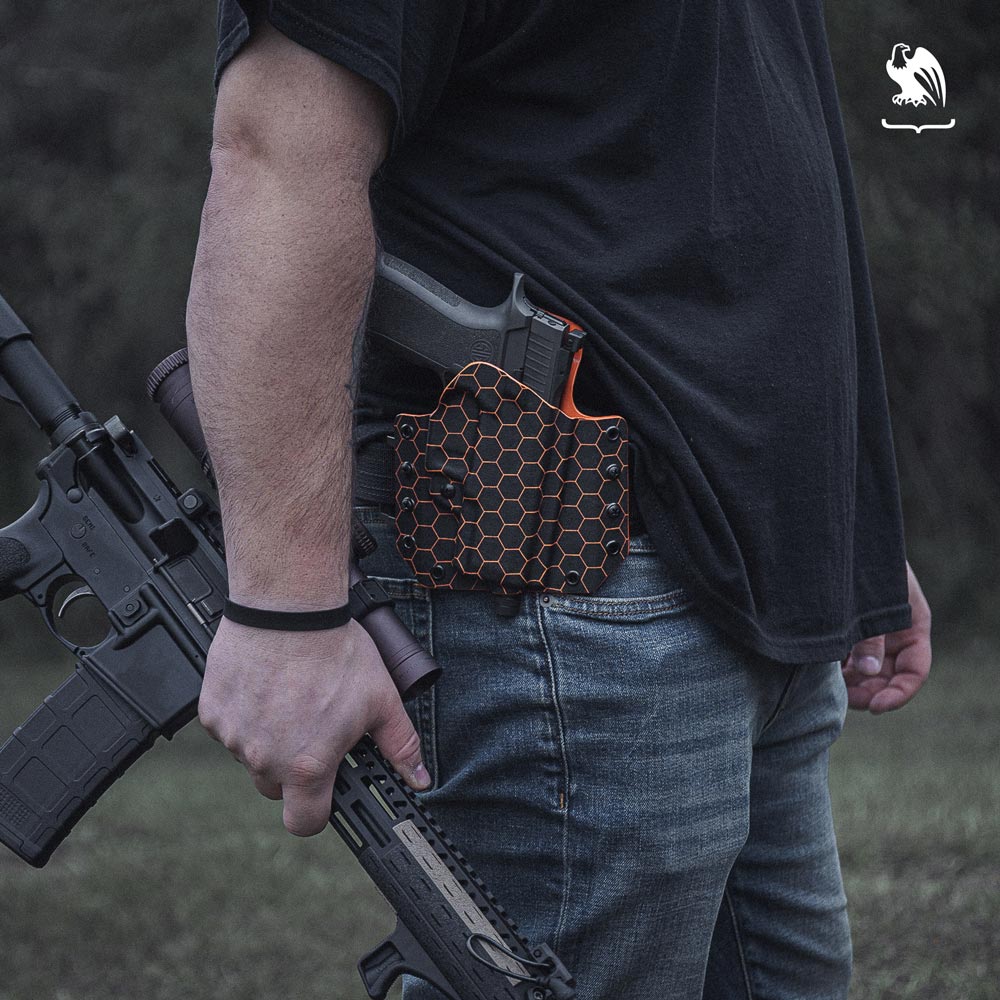 What Type of Firearm Do You Want? - Vedder Holster Generic Photography of a man carrying a handgun on a OWB Holster and a rifle