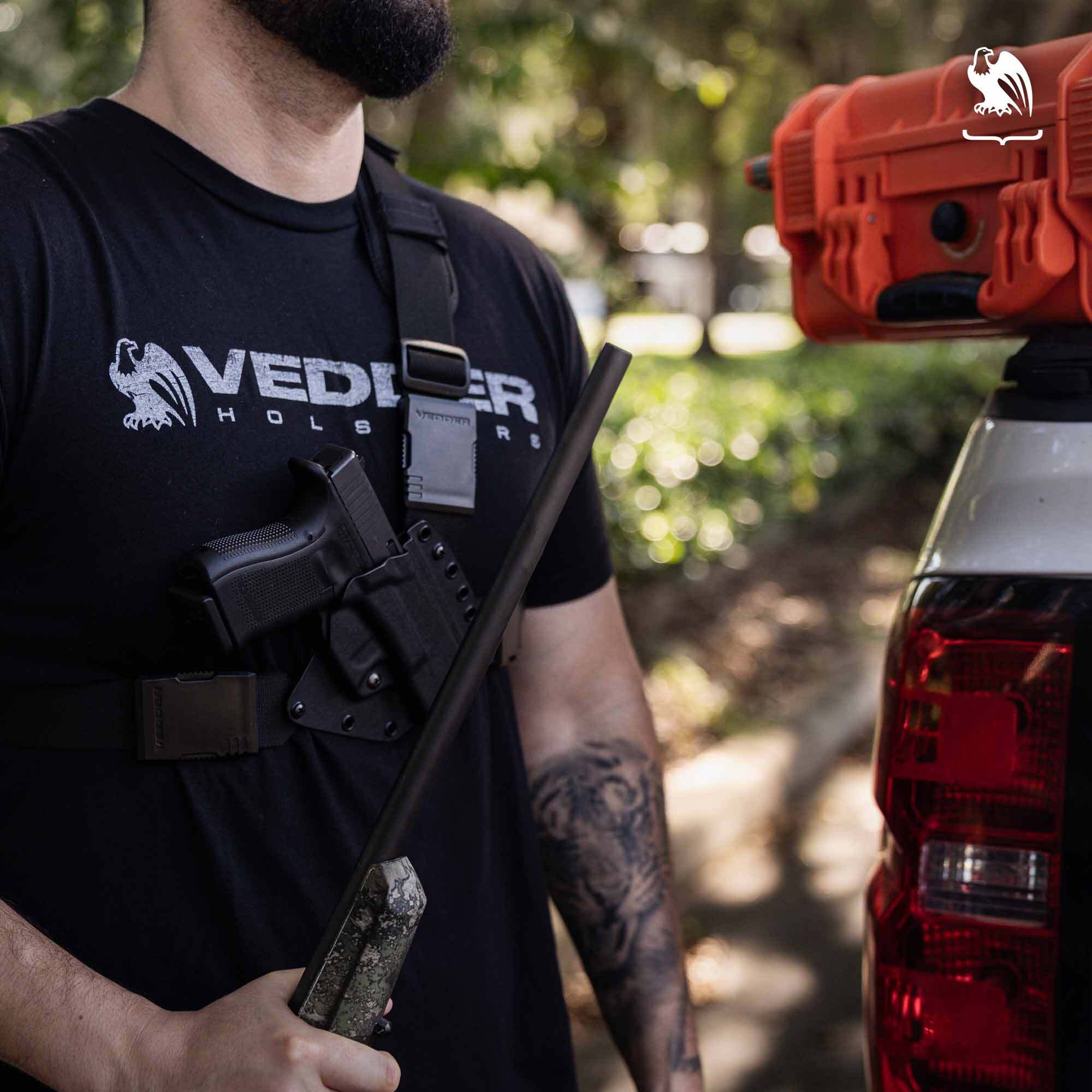 Man wearing a Vedder Holsters chest holster with a Glock pistol on a Evertrek chest holster secured for outdoor carry.